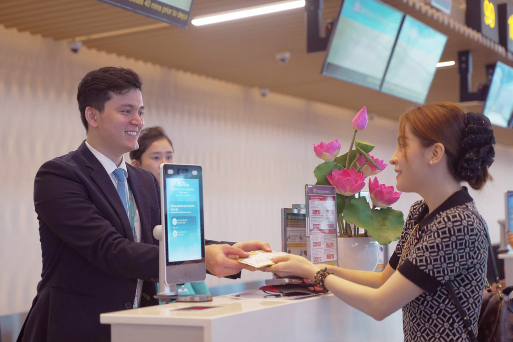 A passenger checking in at a Vietnam Airlines counter for Vietnam domestic flights