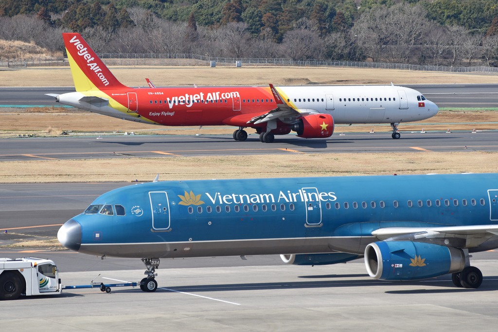 Vietjet and Vietnam Airlines planes on the taxiway, the two biggest domestic airlines in Vietnam