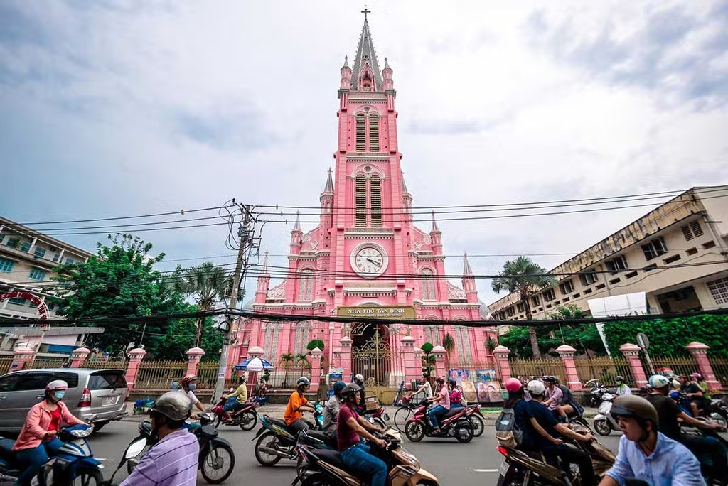 Tan Dinh Church, the pink Catholic church in Ho Chi Minh City, with motorbikes passing