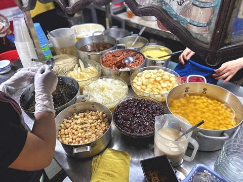 Bowls of beans, jellies and toppings at a sweet soup stall in Saigon
