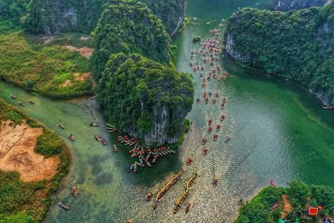 Boats on the river between the limestone peaks of Ninh Binh, from above