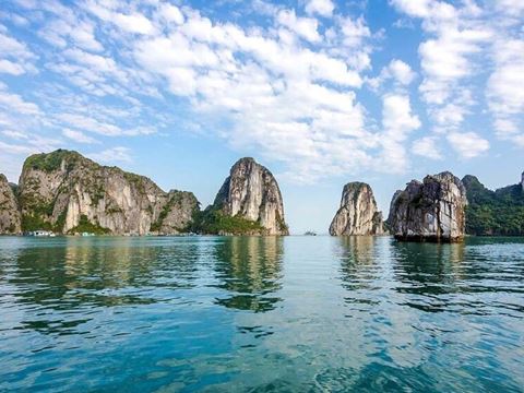 Calm water and limestone islands on Ha Long Bay in the morning