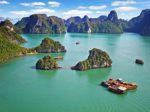 Limestone islands and boats on Ha Long Bay