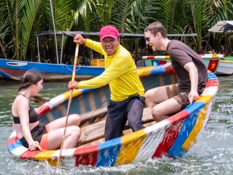 Paddling a round basket boat through the water coconut forest at Cam Thanh